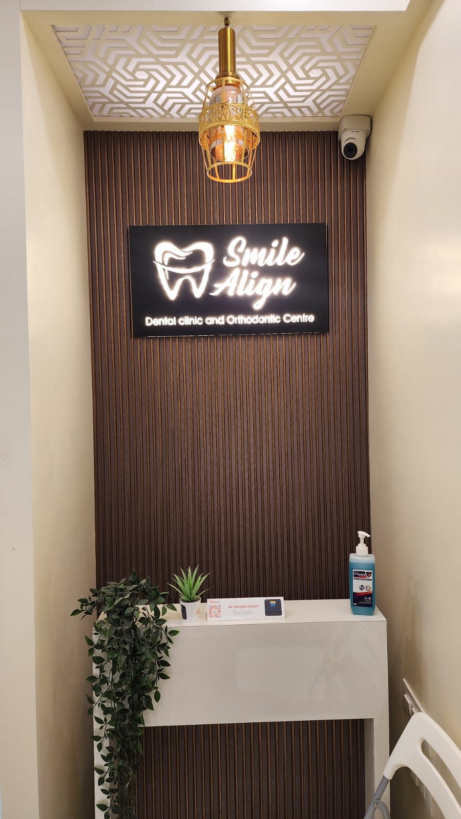Reception at Smile Align Dental Clinic, with the backlit Smile Align sign on a wooden wall