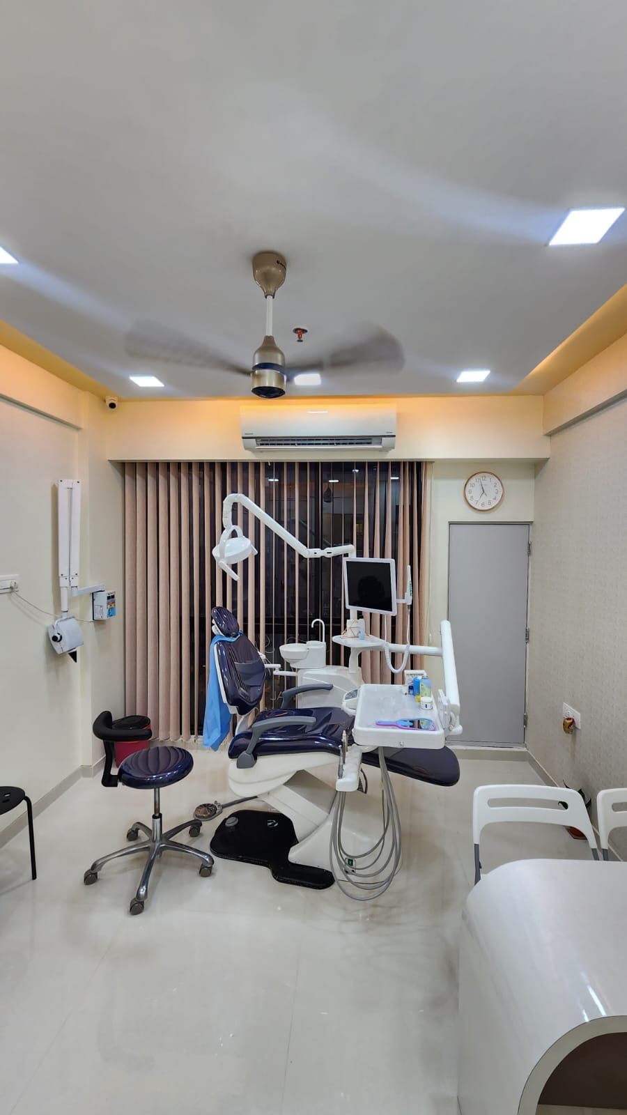 Full view of the treatment room with the dental chair and instrument cabinets