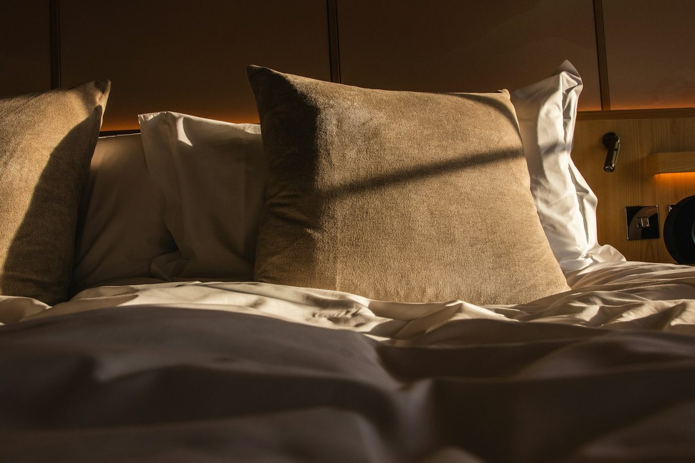 Pillows on a bed in warm evening light